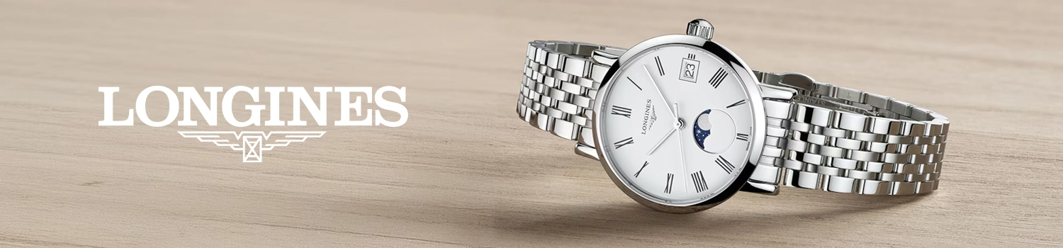Longines Elegant klocka med vit urtavla och stållänk ligger ner på ett träbord