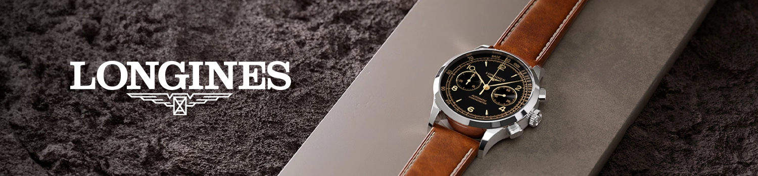 Longines Record herrklocka med svart urtavla och brunt läderarmband ligger på en grå platta