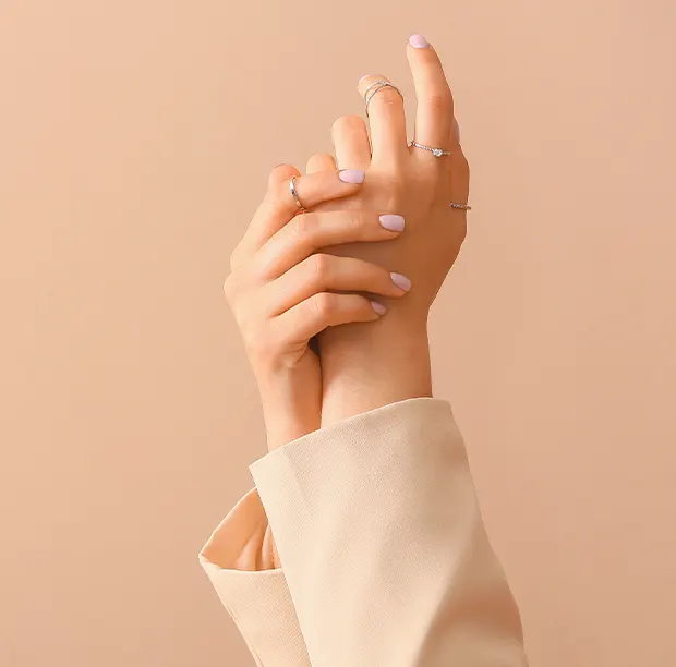 två kvinnliga händer med ringar på flera fingrar