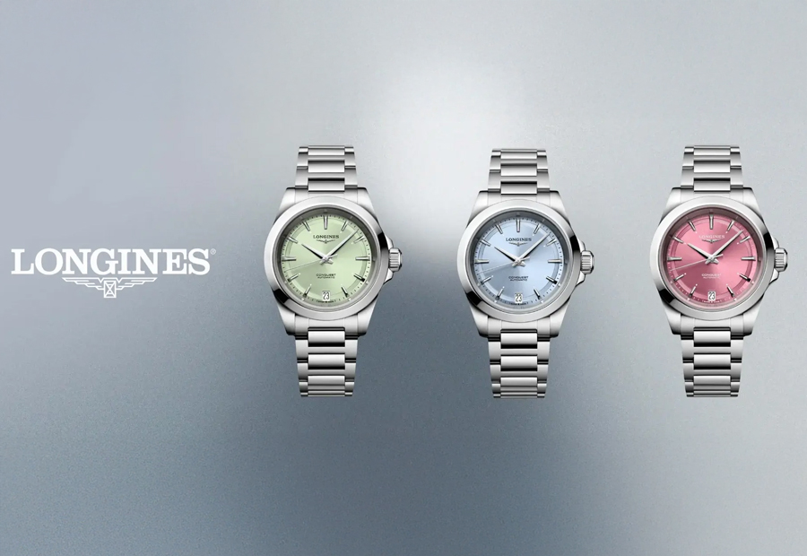 Tre eleganta Longines Conquest damklockor i rostfritt stål med urtavlor i grönt, blått och rosa.